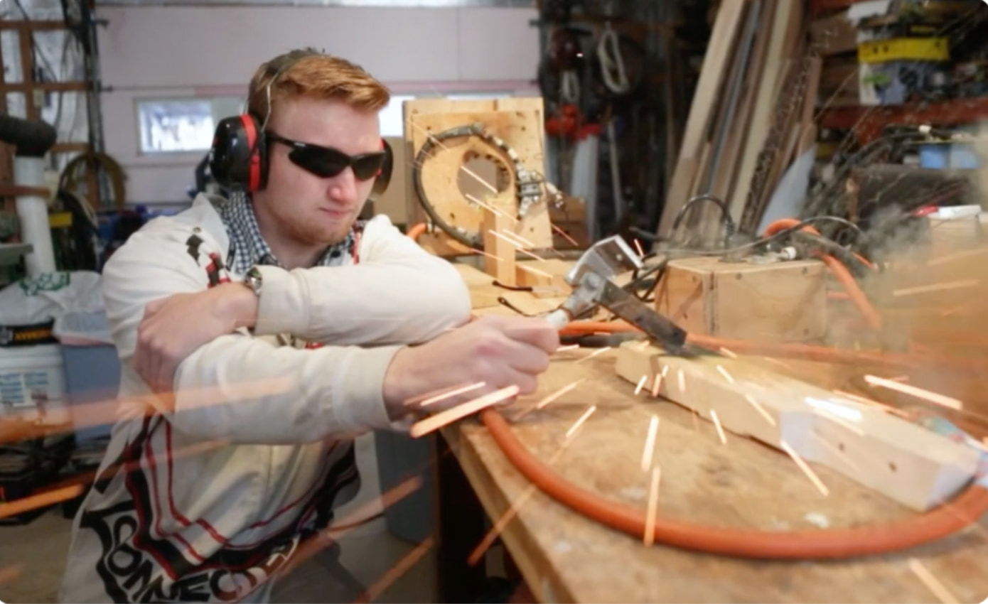 Student working on hands-on CTE project with sparks flying